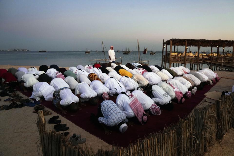 Men pray in Katara beach, Doha, Qatar, Monday, Nov. 28, 2022. (AP Photo/Jorge Saenz)