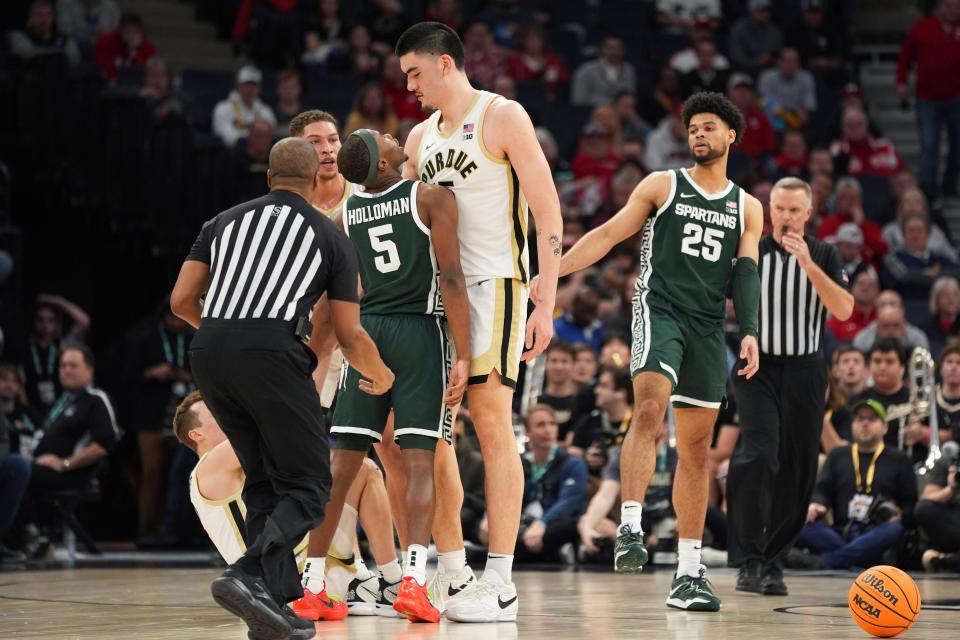 Michigan State guard Tre Holloman (5) and Purdue center Zach Edey, center, get into an altercation during the second half of an NCAA college basketball game in the quarterfinal round of the Big Ten Conference tournament, Friday, March 15, 2024, in Minneapolis. (AP Photo/Abbie Parr)