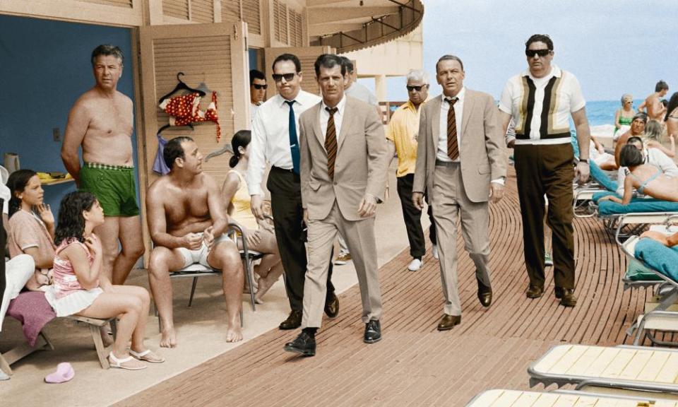 Frank Sinatra with his minders and stand-in, who is wearing an identical outfit to the singer and actor, in Miami Beach while filming The Lady in Cement in 1968.