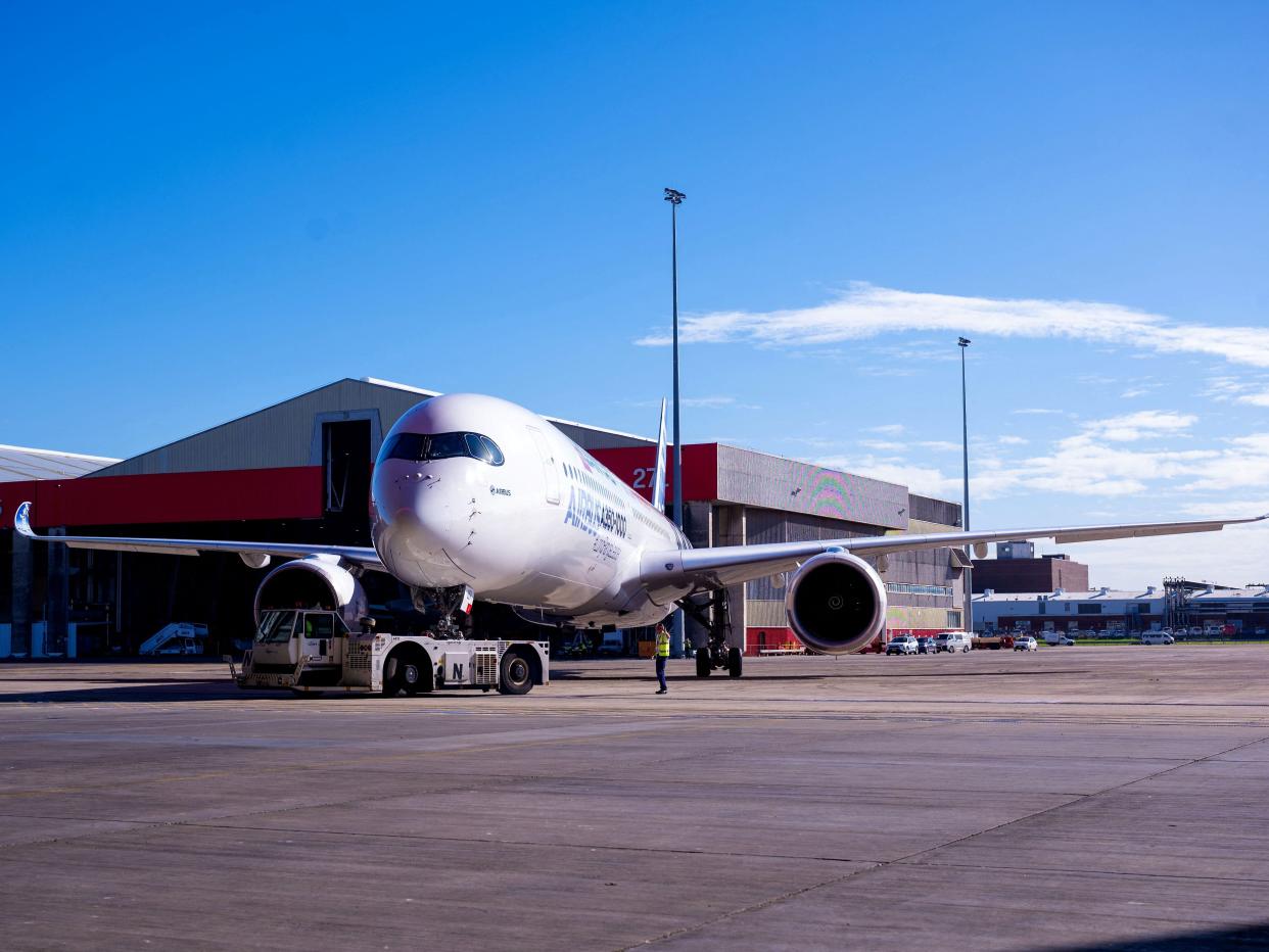 An Airbus A350-1000 aircraft is parked on the tarmac at Sydney international airport on May 2, 2022, to mark a major fleet announcement by Australian airline Qantas. - Qantas announced on May 2 it will launch the world's first non-stop commercial flights from Sydney to London and New York by the end of 2025, finally conquering the "tyranny of distance".