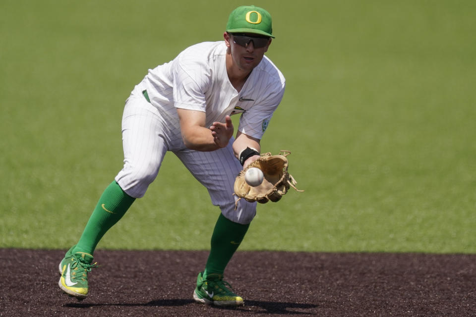 Oregon shortstop Drew Cowley pulls in a ground ball against Xavier during the ninth inning of an NCAA college baseball tournament regional game Friday, June 2, 2023, in Nashville, Tenn. (AP Photo/George Walker IV)