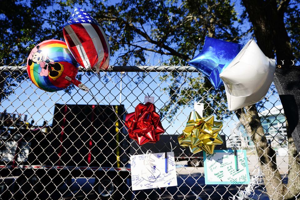Letters and balloons are seen outside of the canceled Astroworld festival at NRG Park Saturday in Houston.