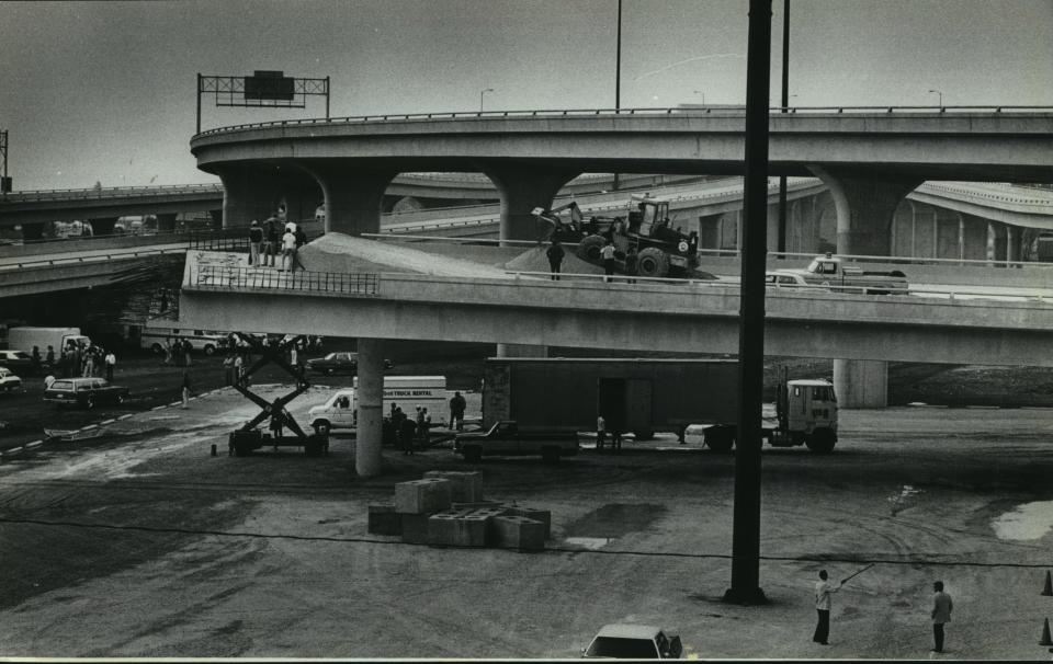 A film crew stands by as machinery goes to work preparing for a crash scene at the unfinished end of the East-West Freeway near the Summerfest grounds on Aug. 28, 1979.