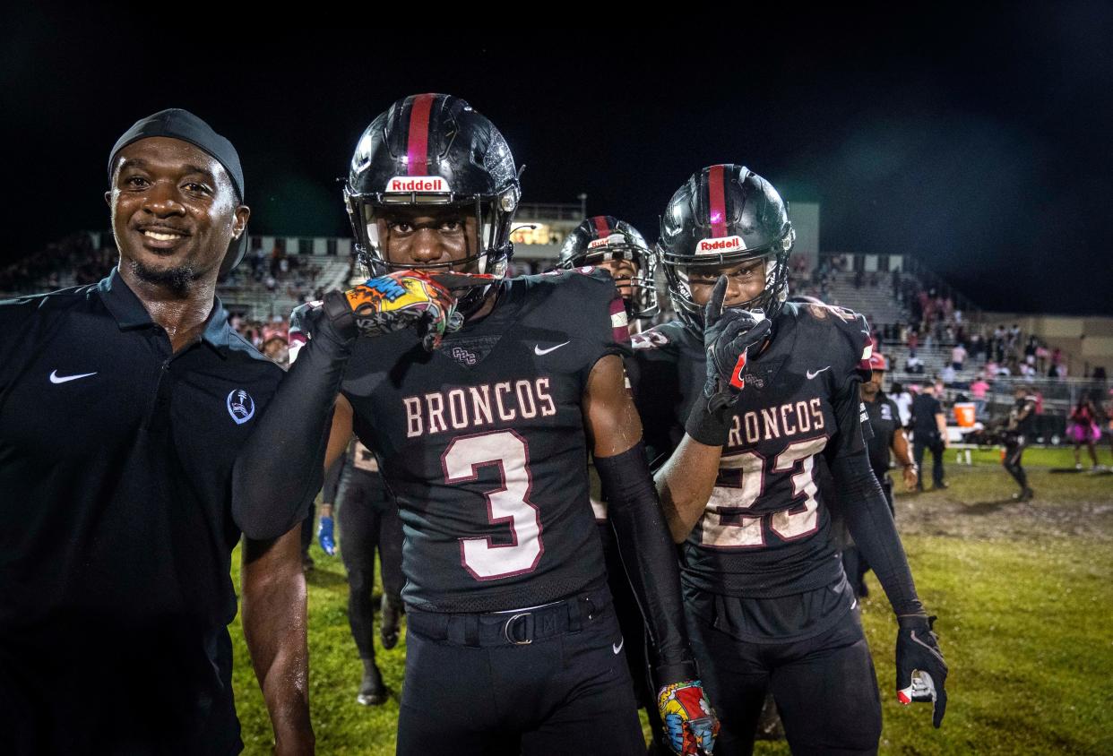 Palm Beach Central players Tony Williams, (3) and Cameron Dwyer, (23) celebrate their 27-24 win over Benjamin in Wellington, Florida on October 6, 2023.
