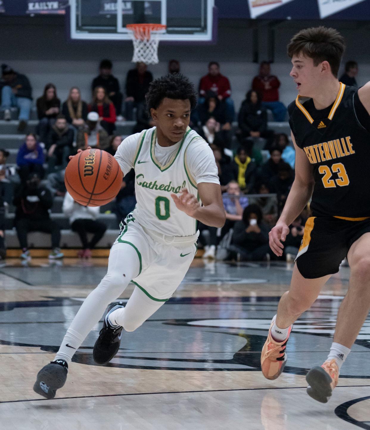 Cathedral Irish Lebron Gough (0) drives past Centerville’s Collin O’Connor (23) during the Sneakers for Santa Shootout Saturday, Dec. 3, 2022, at Brownsburg High School.