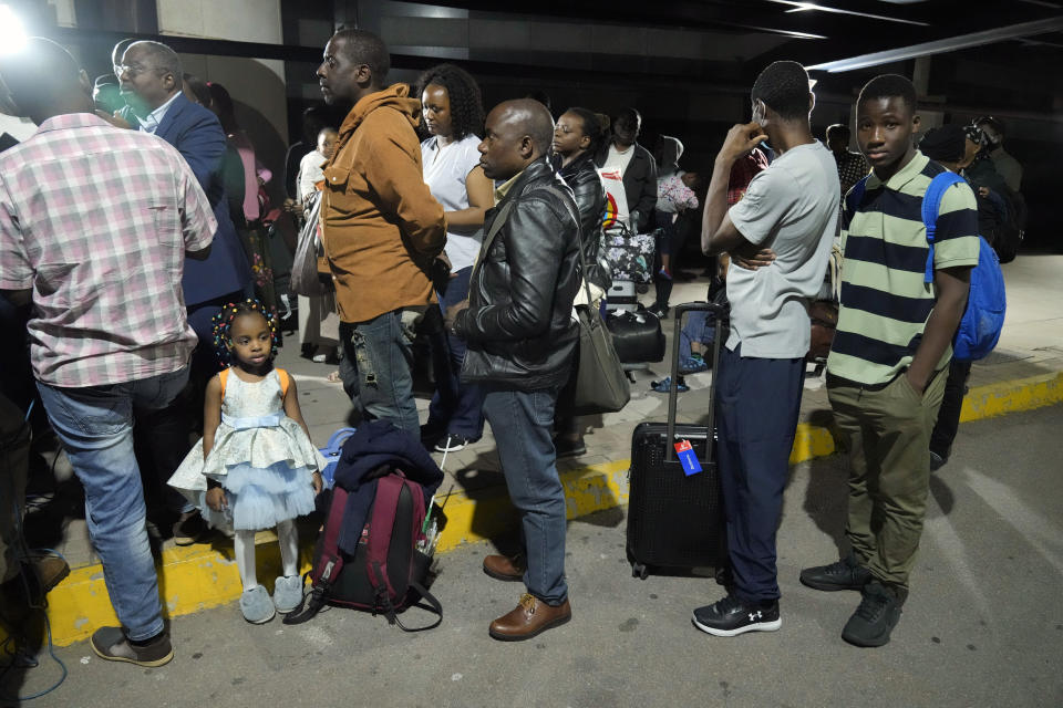 FILE- Zimbabwean evacuees from Sudan arrive at the Robert Mugabe International airport in Harare, Zimbabwe, Friday, April, 28, 2023. Zimbabwe received its first batch of 42 evacuees from Sudan, Friday according to the countries authorities. Many Africans escaping the conflict in Sudan that erupted with little warning last month faced a long wait - three weeks for some - to get out and severe challenges on the way as their governments stuggled to mobilize resources. (AP Photo/Tsvangirayi Mukwazhi, File)