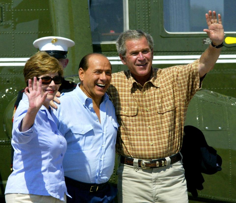The former Italian prime minister with George W Bush, right, and first lady Laura Bush, on his arrival at Bush’s Prairie Chapel Ranch in Texas in 2003 (AFP/Getty)