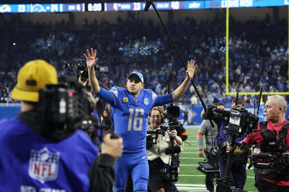 DETROIT, MI - JANUARY 14: Detroit Lions quarterback Jared Goff (16) gestures to fans as he runs off of the field with the media following him at the conclusion of an NFL NFC Wild Card playoff football game between the Los Angeles Rams and the Detroit Lions on January 14, 2024 at Ford Field in Detroit, Michigan. (Photo by Scott W. Grau/Icon Sportswire via Getty Images)