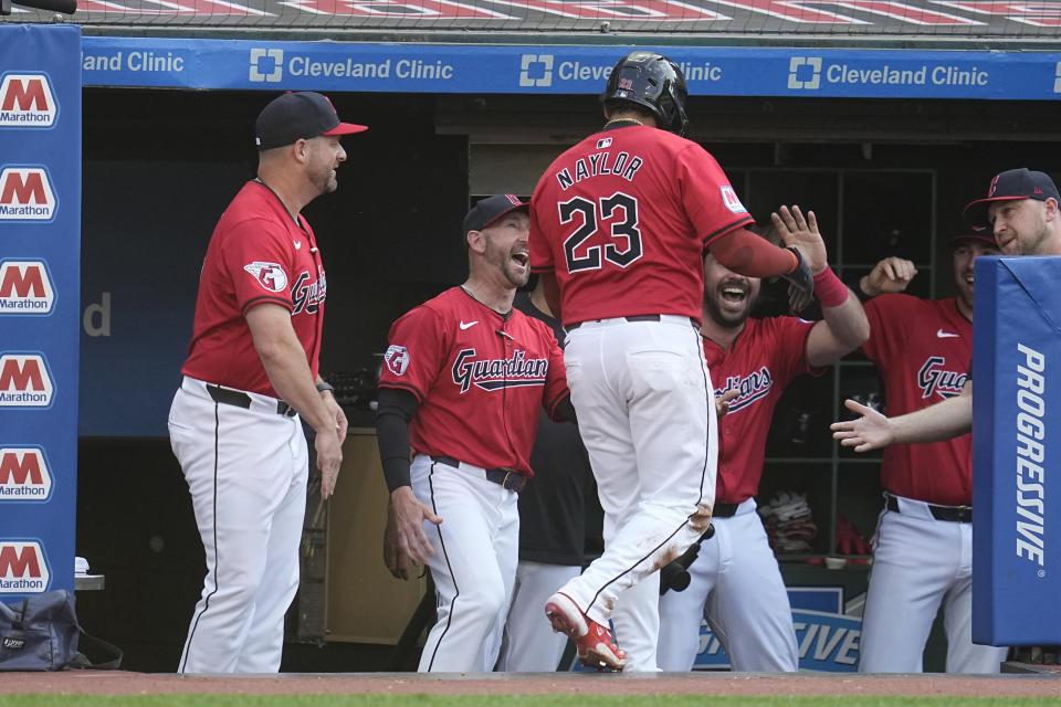 Cleveland Guardians' Josh Naylor (22) is greeted as he returns to the dugout after scoring against the New York Mets during the third inning of a baseball game Tuesday, May 21, 2024, in Cleveland. (AP Photo/Sue Ogrocki)