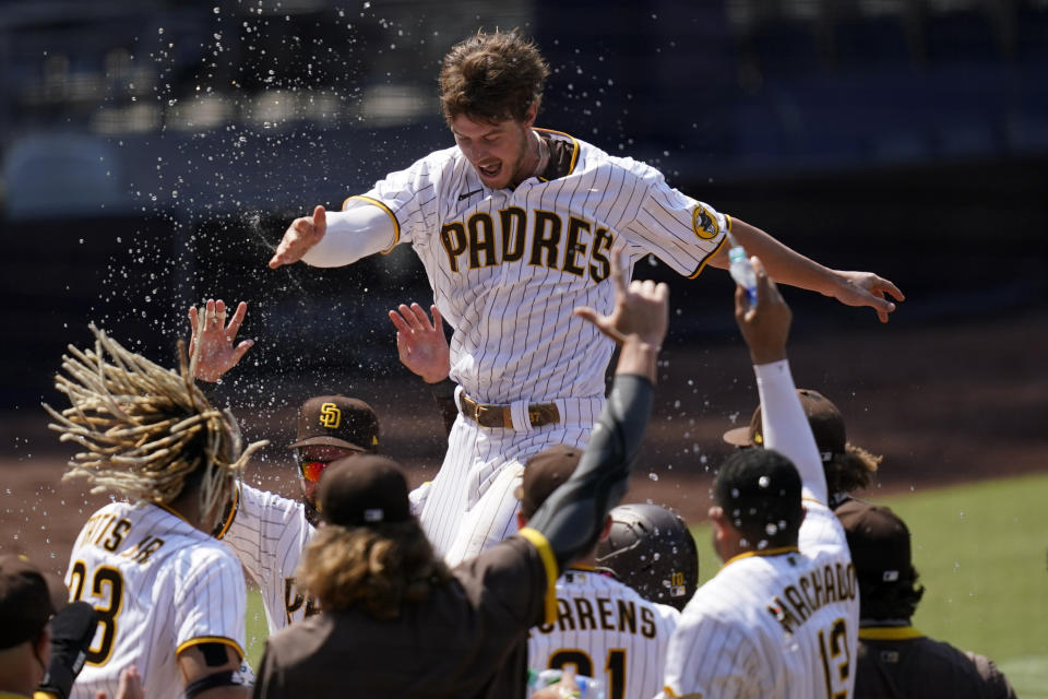 San Diego Padres' Wil Myers, top, reacts after hitting a three-run walkoff home run to defeat the Seattle Mariners in a baseball game Thursday, Aug. 27, 2020, in San Diego. (AP Photo/Gregory Bull)