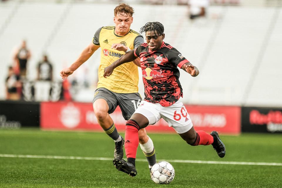 Curtis Ofori moves the ball up field during a 2022 USL soccer game as a member of the New York Red Bulls II.