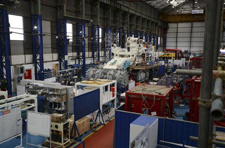 Employees of Soil Machine Dynamics (SMD) work on a subsea mining machine being built for Nautilus Minerals at Wallsend, northern England April 14, 2014. REUTERS/ Nigel Roddis