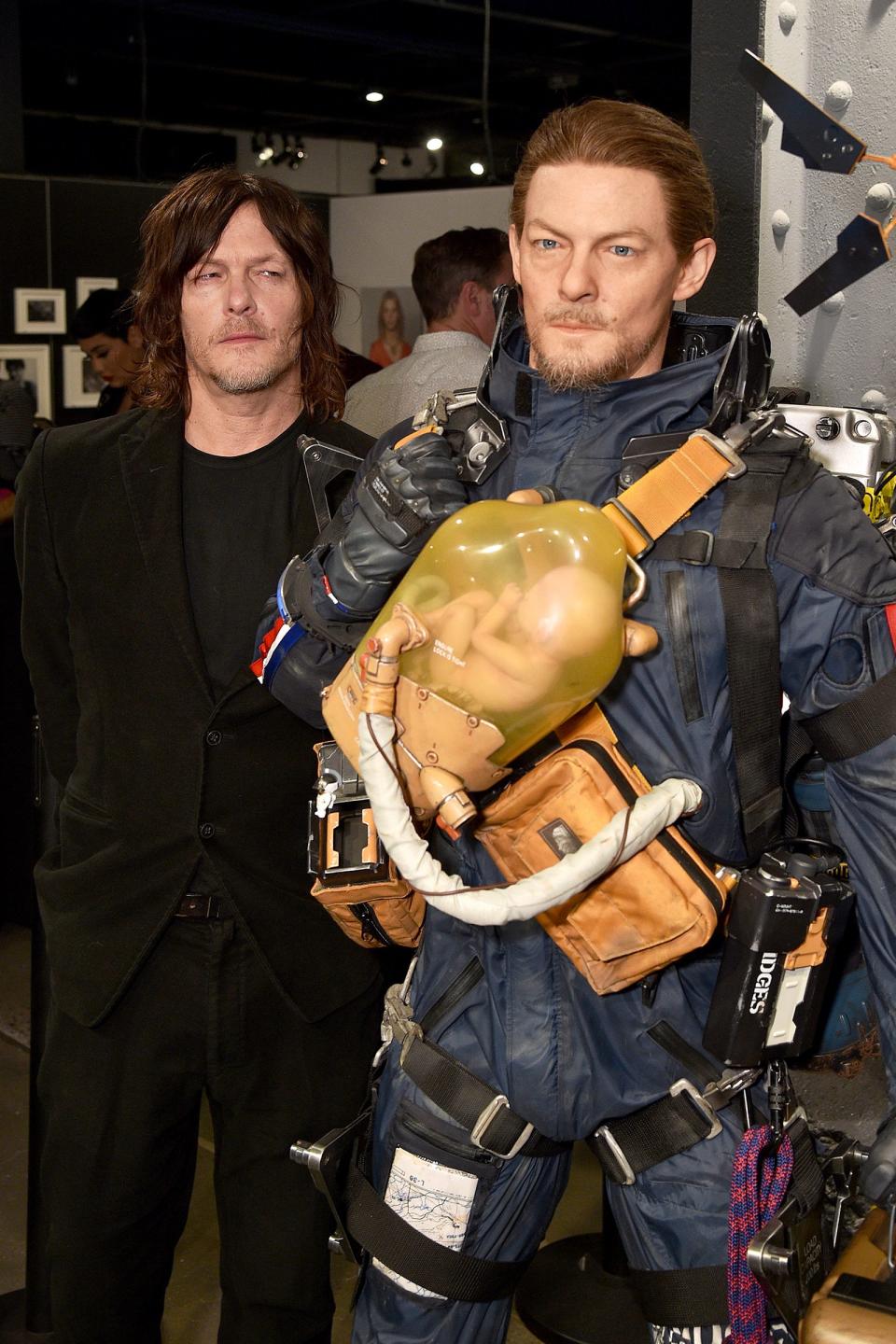 Norman Reedus checks himself out while attending Fractured Worlds: The Art of DEATH STRANDING on Tuesday in N.Y.C. 