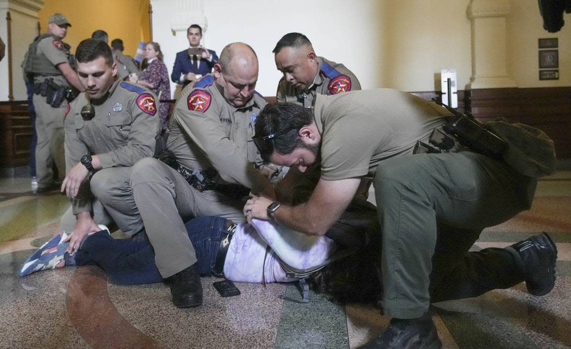 LGBTQ rights activist Adri Perez is detained by Department of Public Safety troopers as activists protest SB14 outside the House of Representatives gallery at the Capitol Tuesday, May 2, 2023. SB14 would ban gender-affirming medical care for transgender children.