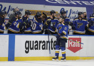 St. Louis Blues' Jaden Schwartz (17) celebrates with Ryan O'Reilly (90) and other teammates after scoring a goal in the first period of an NHL hockey game against the Minnesota Wild, Wednesday, May 12, 2021 in St. Louis. (AP Photo/Tom Gannam)