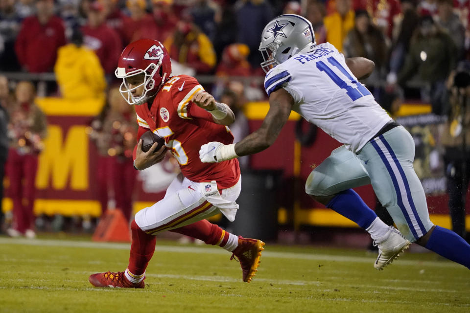 Kansas City Chiefs quarterback Patrick Mahomes, left, runs before being sacked by Dallas Cowboys linebacker Micah Parsons (11) during the second half of an NFL football game Sunday, Nov. 21, 2021, in Kansas City, Mo. (AP Photo/Ed Zurga)