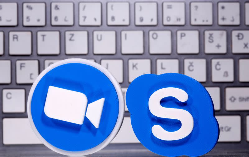 FILE PHOTO: A 3D printed Skype and Zoom logo are placed in front of keyboard in this illustration taken