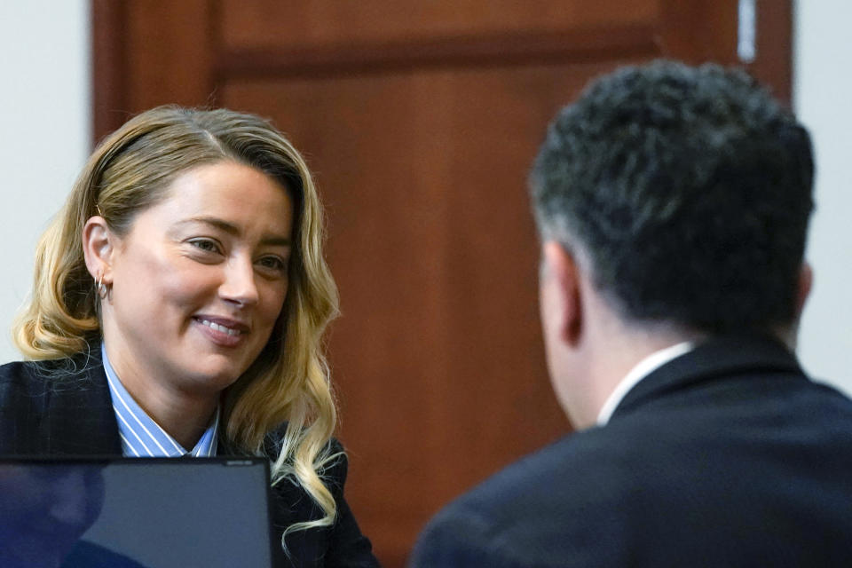 Actor Amber Heard speaks with her attorney in the courtroom at the Fairfax County Circuit Court in Fairfax, Va., Wednesday May 4, 2022. Actor Johnny Depp sued his ex-wife Amber Heard for libel in Fairfax County Circuit Court after she wrote an op-ed piece in The Washington Post in 2018 referring to herself as a "public figure representing domestic abuse." (Elizabeth Frantz/Pool Photo via AP)