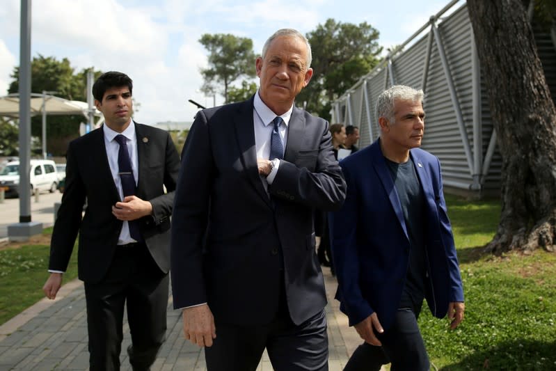 FILE PHOTO: Benny Gantz and Yair Lapid, leaders of of Blue and White party, arrive to hold a news conference in Tel Aviv, Israel