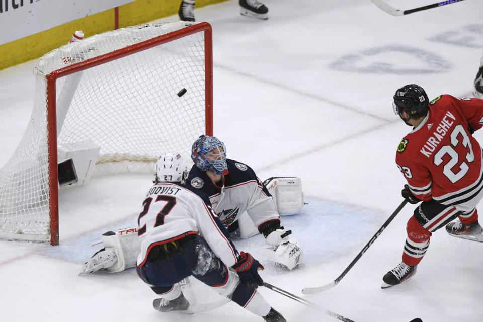 Chicago Blackhawks' Philipp Kurashev (23) scores a goal against Columbus Blue Jackets goalie Elvis Merzlikins during the first period of an NHL hockey game Saturday, March 2, 2024, in Chicago. (AP Photo/Paul Beaty)