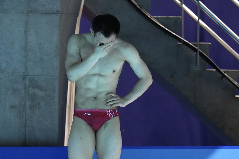 First placed Xie Siyi of China breaks into tears after completing the men's diving 3-meter springboard final at the 2020 Summer Olympics, Tuesday, Aug. 3, 2021, in Tokyo, Japan. (AP Photo/Alessandra Tarantino)