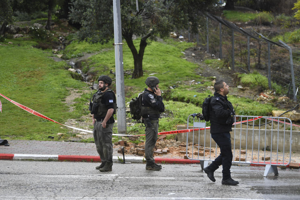 Israeli security forces examine the site hit by a rocket fired from Lebanon, in Safed, northern Israel, Wednesday, Feb. 14, 2024. Israeli media reported 1 killed and eight wounded in the rocket attack. The town, which is around 12 kilometers (7 miles) from the border is farther south than most of the daily border skirmishes with Lebanon's Hezbollah militant group. (AP Photo/Gil Eliyahu)