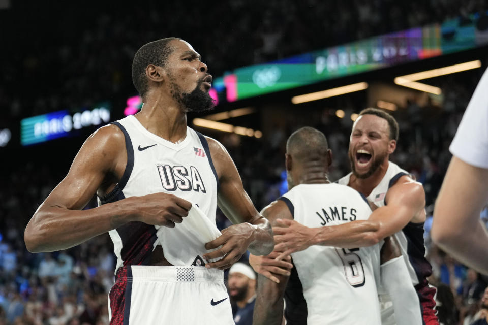 Kevin Durant, LeBron James and Steph Curry revel in a well-deserved victory. (AP Photo/Mark J. Terrill)