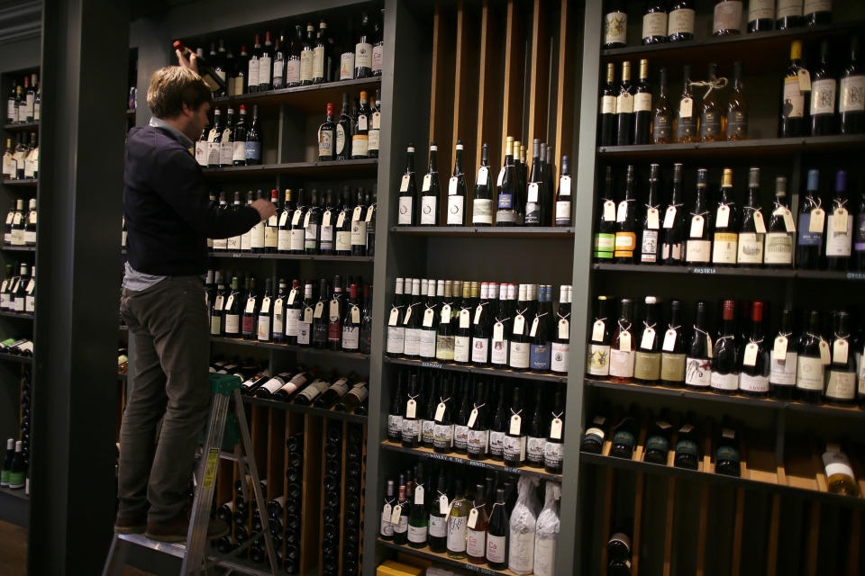 BOSTON, MA - JANUARY 4: Michael Dupuy stocks wine bottles at his shop, Street Car Wine & Beer, in the Jamaica Plain neighborhood of Boston on Jan. 4, 2020. Dupuy started an online petition to oppose the Trump administration's proposed 100 percent tariff on European wine. In October, the World Trade Organization determined the subsidies were illegal and authorized the US to impose tariffs on $7.5 billion in European goods. The Trump administration then levied a 10 percent tax on aircraft  and a 25 percent tax on a long list of products including Parmesan cheese, single-malt Scotch, olive oil, and many wines from France, Spain, Germany, and the UK. (Photo by Jonathan Wiggs/The Boston Globe via Getty Images)