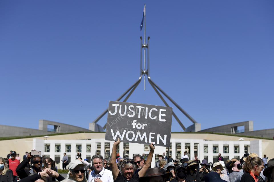 A protesters holds a placard during the Women's March 4 Justice in Canberra, Australia, Monday, March 15, 2021. The rally was one of several across Australia including in Sydney, Melbourne, Brisbane and Hobart calling out sexism, misogyny and dangerous workplace cultures. (Mick Tsikas/AAP Image via AP)