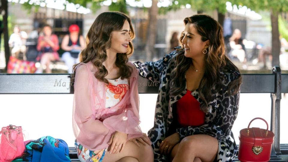 Emily in Paris. (L to R) Lily Collins as Emily, Ashley Park as Mindy in episode 210 of Emily in Paris. Cr. Stéphanie Branchu/Netflix © 2021