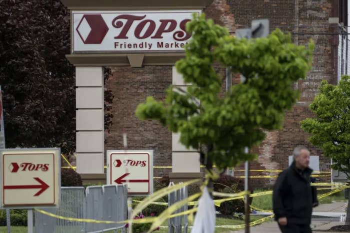 The outside of a Tops grocery store with caution tape flanking the area