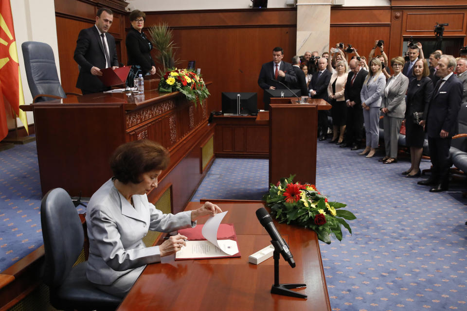 Gordana Siljanovska Davkova signs the oath as the new President of North Macedonia in front of the lawmakers, during an inauguration ceremony at the parliament building in Skopje, North Macedonia, on Sunday, May 12, 2024. Siljanovska Davkova has sworn as first female president in North Macedonia on Sunday after her triumph in a presidential runoff earlier this week over the leftist incumbent president. (AP Photo/Boris Grdanoski)