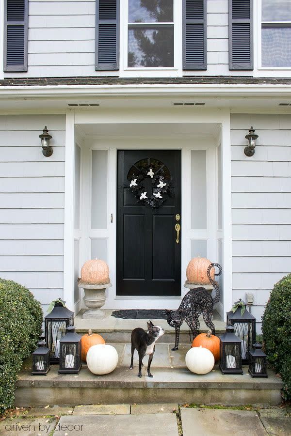 <p>Keep your outdoor decor simple with pumpkins, lanterns, and a sassy black cat.</p><p><strong>Get the tutorial at <a href="https://www.drivenbydecor.com/halloween-decorating-ikea-sallskap/" rel="nofollow noopener" target="_blank" data-ylk="slk:Driven by Decor;elm:context_link;itc:0;sec:content-canvas" class="link ">Driven by Decor</a>.</strong> </p>