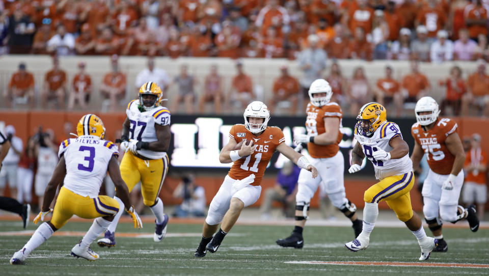 Texas Longhorns quarterback Sam Ehlinger #11 looks for running room between LSU Tigers defenders Saturday Sept. 7, 2019 at Darrell K Royal-Texas Memorial Stadium in Austin, Tx. ( Photo by Edward A. Ornelas )