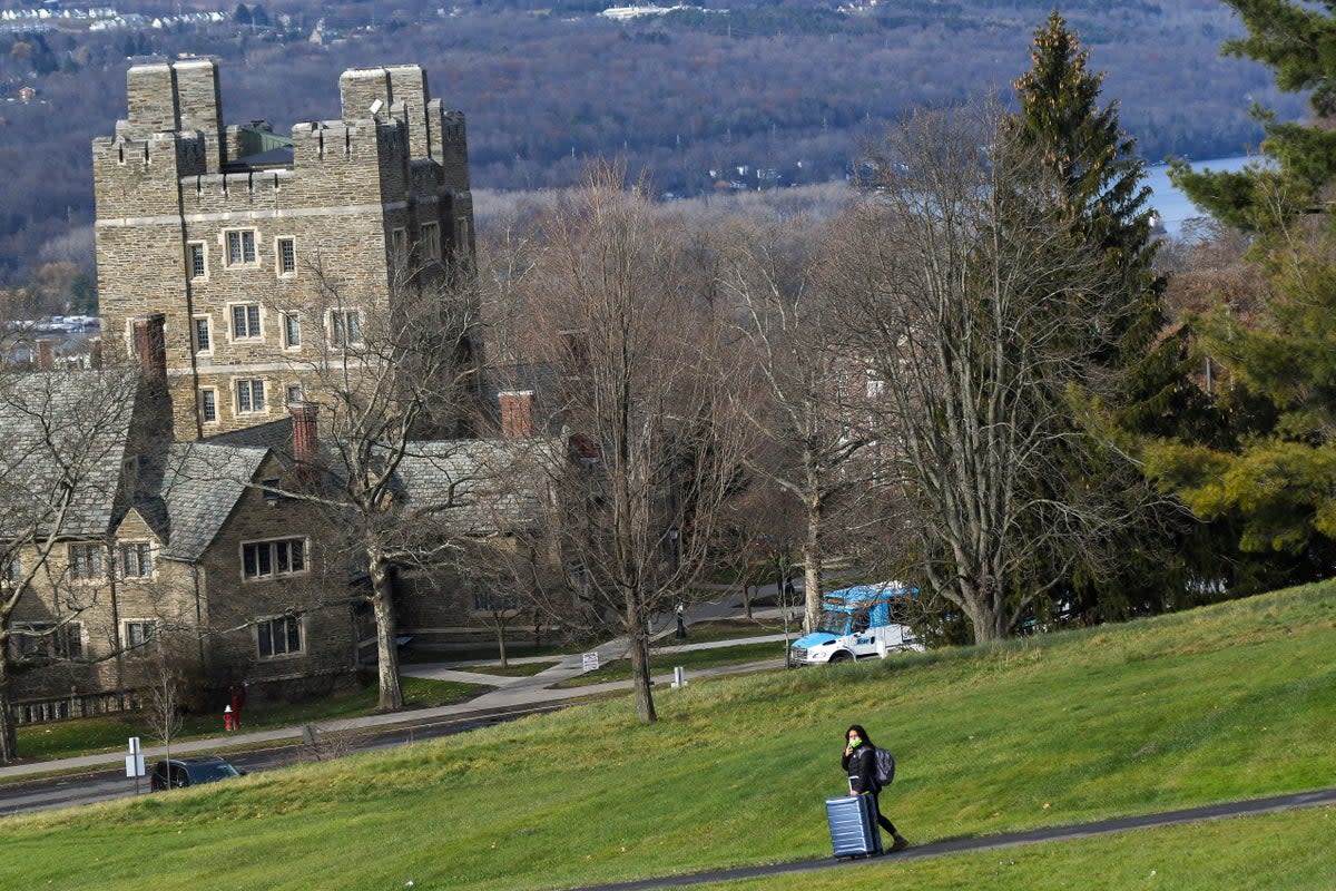 A Cornell University student walks along the campus in Ithaca, N.Y., on Dec. 16, 2021 (AP)