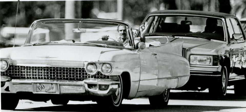 Burt Reynolds appears to be stuck in a traffic jam along Royal Poinciana Way in Palm Beach in November 1988. The Palm Beach County native was filming a scene for his TV show "B.L. Stryker."