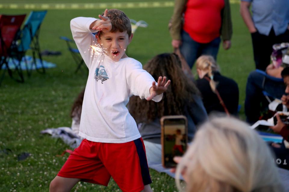 Kids play with sparklers before Portsmouth's fireworks show Monday, July 5, 2021 in celebration of the Fourth of July.