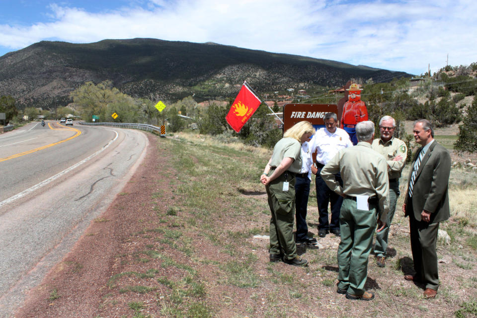 U.S. Forest Service officials talk with local firefighters and county leaders about the wildfire outlook following a news conference at the Sandia Ranger Station in Tijeras, N.M. on Thursday, April 26, 2012. Federal officials expect the 2012 season to be just as active as last year, when historic fires charred hundreds of square miles across parts of Arizona, New Mexico and Texas. (AP Photo/Susan Montoya Bryan)