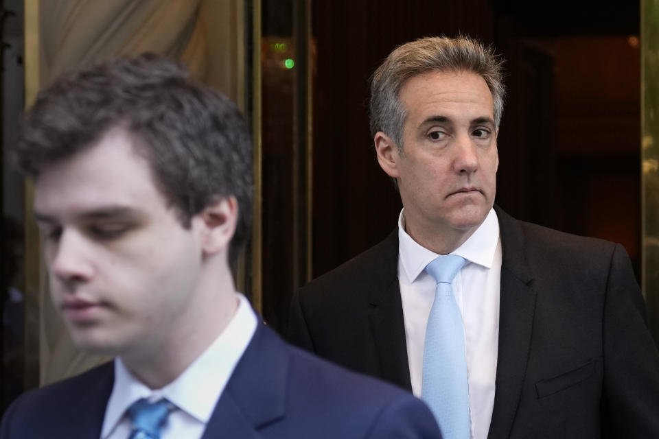 Michael Cohen, right, leaves his apartment building in New York, Tuesday, May 14, 2024. Cohen, former President Donald Trump's fixer-turned-foe is returning to the witness stand for a bruising round of questioning from the former president's lawyers. (AP Photo/Seth Wenig)