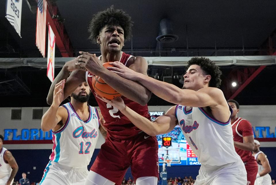 Temple guard Jahlil White (2) and Florida Atlantic guard Johnell Davis (1) go after a rebound during the second half of an NCAA college basketball game, Thursday, Feb. 15, 2024, in Boca Raton, Fla. (AP Photo/Marta Lavandier)