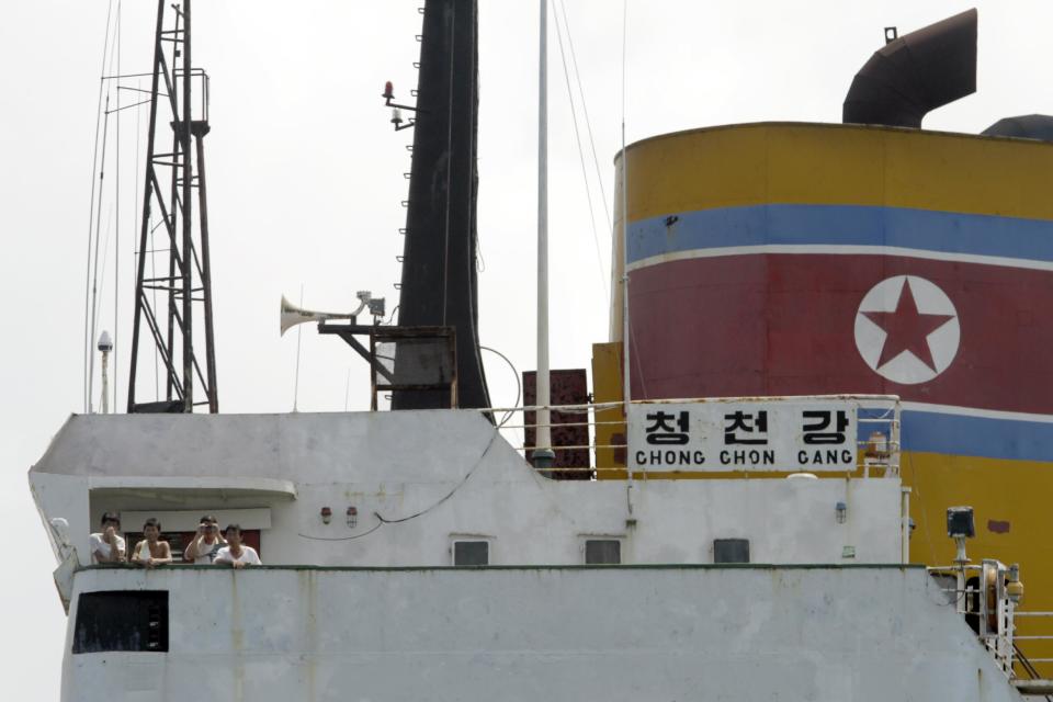 North Korean sailors stand on the deck of the North Korean-flagged cargo ship Chong Chon Gang in Sherman Bay near Colon City, Panama, Wednesday, Feb. 12, 2014. Panama Canal officials say the North Korean ship seized as it was smuggling weapons is free to leave because the owner has paid a fine. Three of the vessel's operators still face charges, while 32 crew members are free to return to North Korea. (AP Photo/Arnulfo Franco)