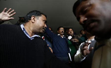 Delhi's Chief Minister Arvind Kejriwal (C), chief of the Aam Aadmi (Common Man) Party (AAP), leaves after addressing the media during a news conference in New Delhi February 11, 2014. REUTERS/Adnan Abidi