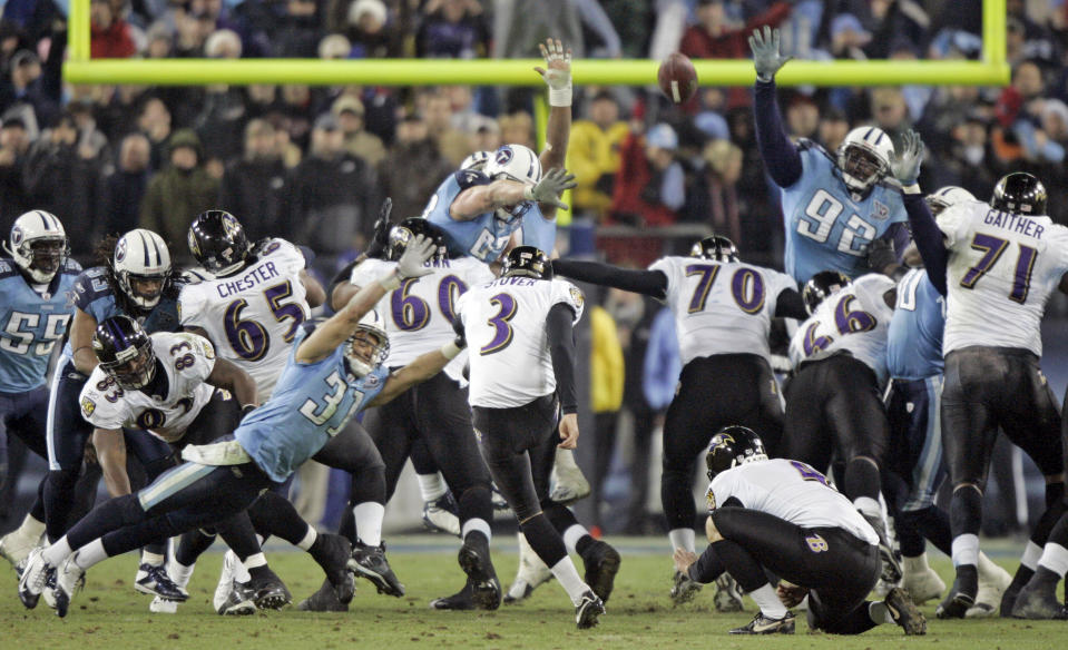 FILE - In this Jan 10, 2009, file photo, Baltimore Ravens' Matt Stover (3) kicks a 43-yard field goal with 53 seconds left in the fourth quarter to give the Ravens a 13-10 win over the Tennessee Titans in an NFL football divisional playoff game in Nashville, Tenn. Titans cornerback Cortland Finnegan (31) and defensive tackle Albert Haynesworth (92) try to block the kick. The Titans playing the Ravens in the divisional round Saturday night, Jan. 11, has revived strong memories of a very intense and bitter playoff rivalry along with the agony of possible Super Bowl titles lost. (AP Photo/Wade Payne, File)