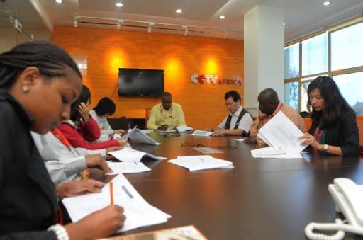 CCTV Africa journalists attend an editorial meeting in the organisation's office in Nairobi. The Chinese TV giant also has programmes in French, Spanish, Arabic and Russian, while the state news agency Xinhua is also expanding worldwide