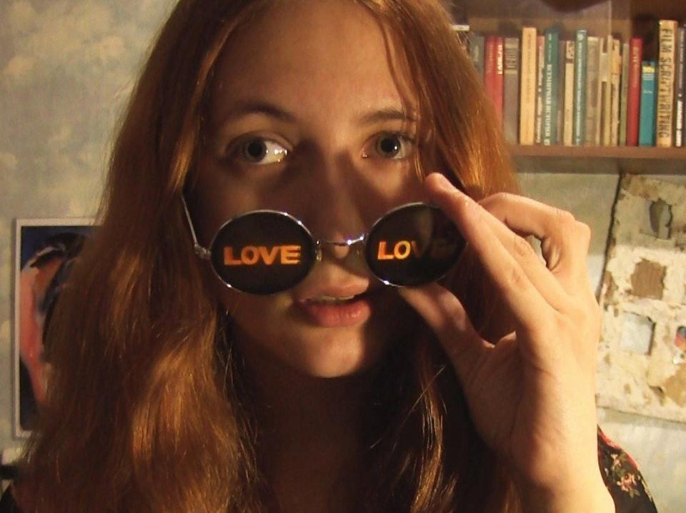 Alexandra Skochilenko wears "Love" sunglasses.