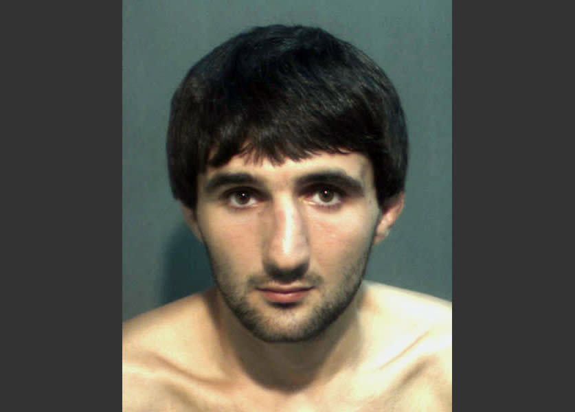 FILE- This May 4, 2013 file photo provided by the Orange County Corrections Department in Orlando, Fla., shows Ibragim Todashev after his arrest for aggravated battery in Orlando. A report released Tuesday, March 25, 2014, determined that an FBI agent was justified in fatally shooting Todashev, who became violent after he had agreed to give a statement about his involvement in a triple slaying in Massachusetts last May. (AP Photo/Orange County Corrections Department)