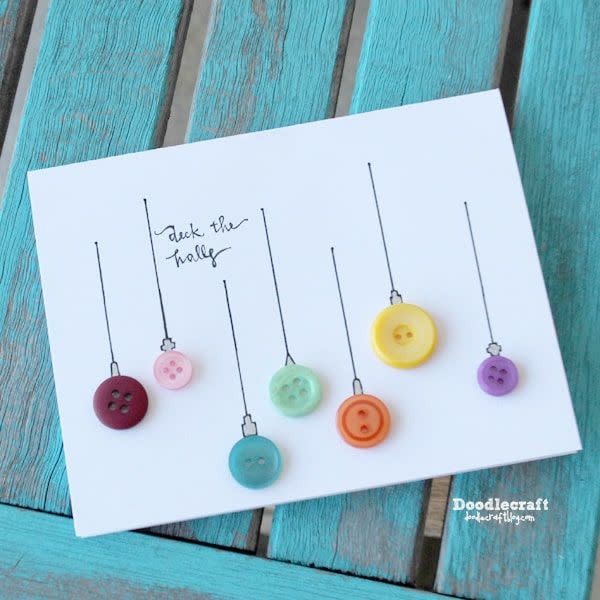 <p>If you have spare or leftover buttons lying around, repurpose them into a holiday card! With a few pen strokes, they can become vintage-looking ornaments.</p><p><a href="https://www.doodlecraftblog.com/2019/07/jeweled-vintage-buttons-christmas-tree.html" rel="nofollow noopener" target="_blank" data-ylk="slk:See the tutorial on Doodlecraft »;elm:context_link;itc:0;sec:content-canvas" class="link "><em>See the tutorial on Doodlecraft »</em></a></p>