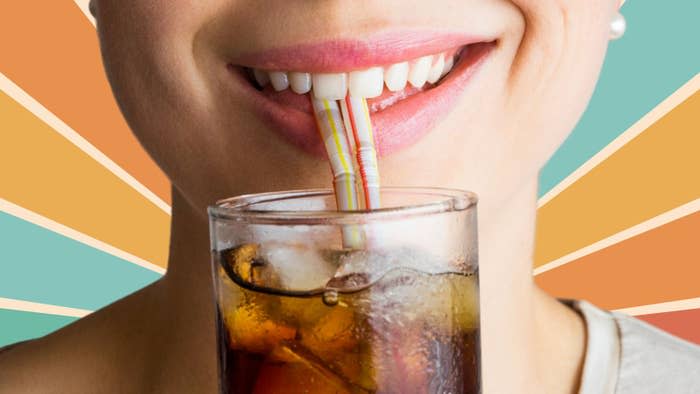 Close-up of a person sipping a soft drink through a straw