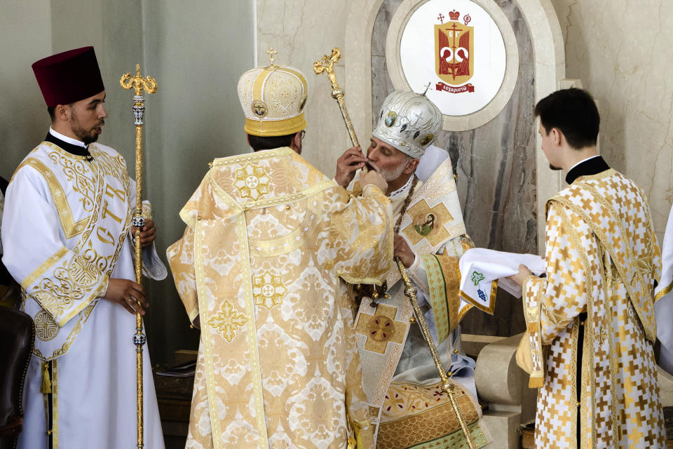 Metropolitan Archbishop of the Ukrainian Catholic Diocese of Philadelphia Borys Gudziak kisses a staff as he is enthroned into his new position at the Ukrainian Catholic Cathedral of the Immaculate Conception in Philadelphia, Tuesday, June 4, 2019. (AP Photo/Matt Rourke)