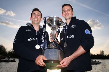 Rowing - BNY Mellon 2015 Oxford v Cambridge University Boat Race - River Thames, London - 11/4/15 Sam O'Connor and James O'Connor of Oxford celebrate winning the Men's Race with the trophy Action Images via Reuters / Paul Childs